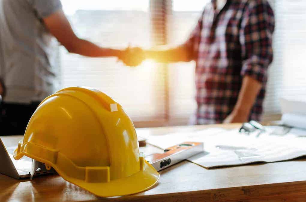 two men shaking hands after while discussing a roof referral program